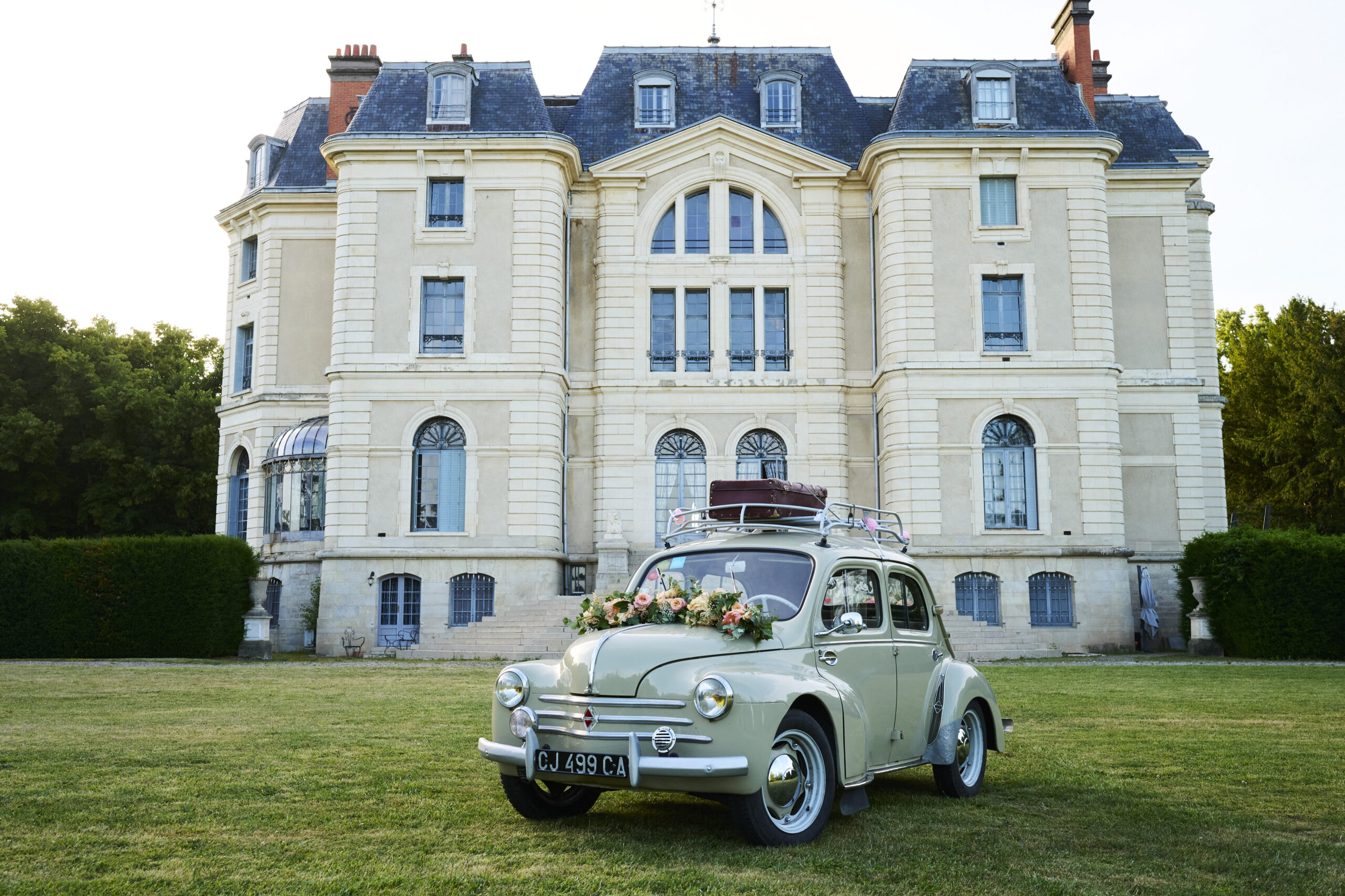 une 4CV verte devant le château la caniere au mariage en auvergne